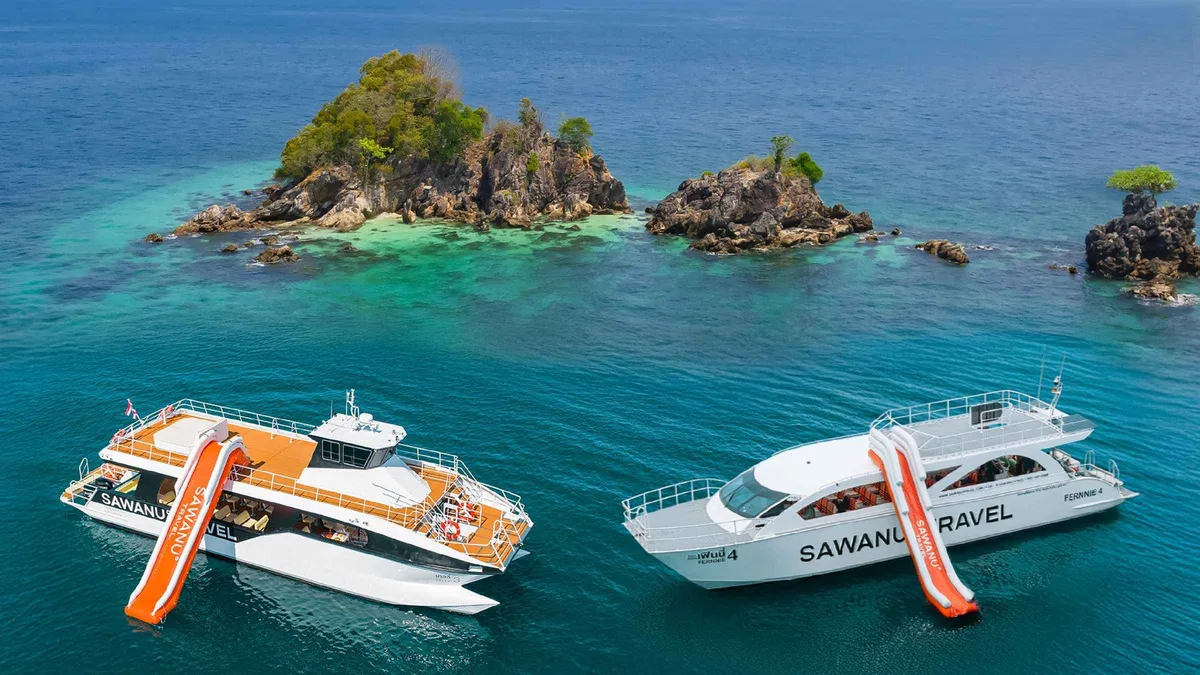 Power catamaran anchored off a white sand beach at Khai Island on a Phuket boat tour to the Phi Phi Islands, Thailand